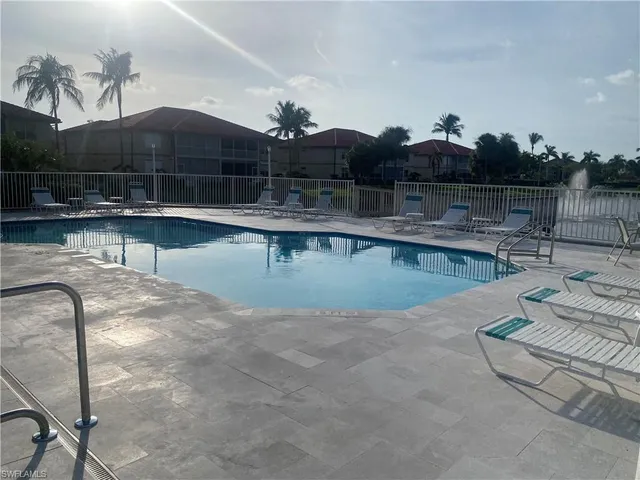 a view of a swimming pool with a lounge chair
