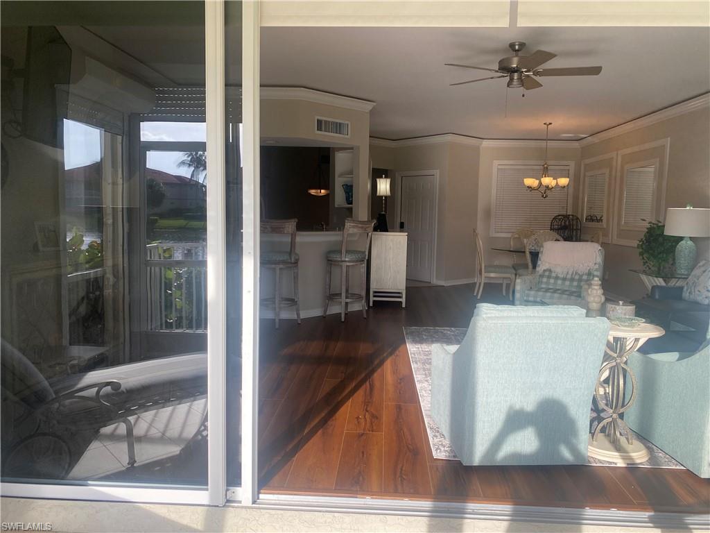 295 Waterside Circle, Unit 1102 Marco Island, FL 34145 - Photo 29 of 31 a living room with furniture and a glass door shower
