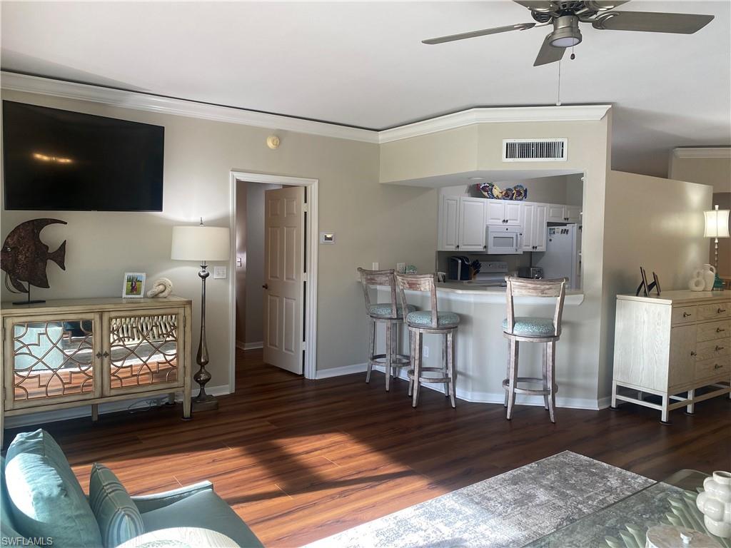 295 Waterside Circle, Unit 1102 Marco Island, FL 34145 - Photo 8 of 31 a living room with furniture and a fireplace