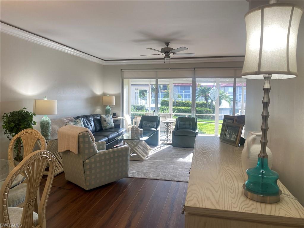 295 Waterside Circle, Unit 1102 Marco Island, FL 34145 - Photo 9 of 31 a living room with furniture and a chandelier