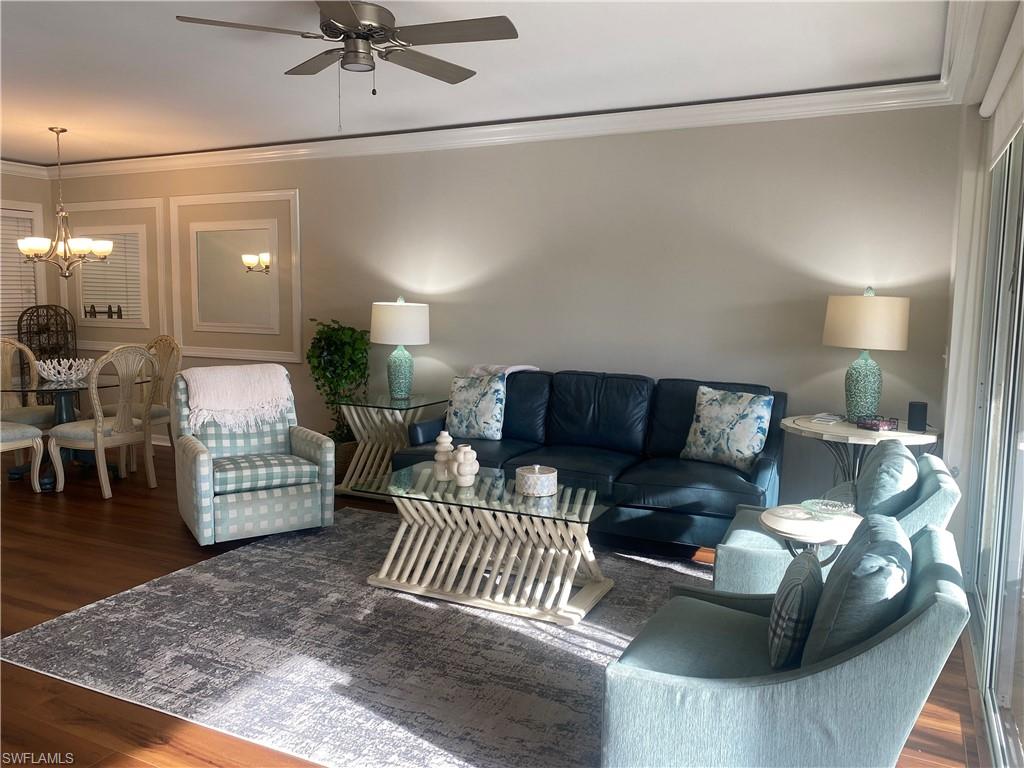 295 Waterside Circle, Unit 1102 Marco Island, FL 34145 - Photo 10 of 31 a living room with furniture and a chandelier