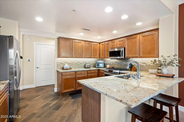 a bathroom with a double vanity sink mirror and bathtub