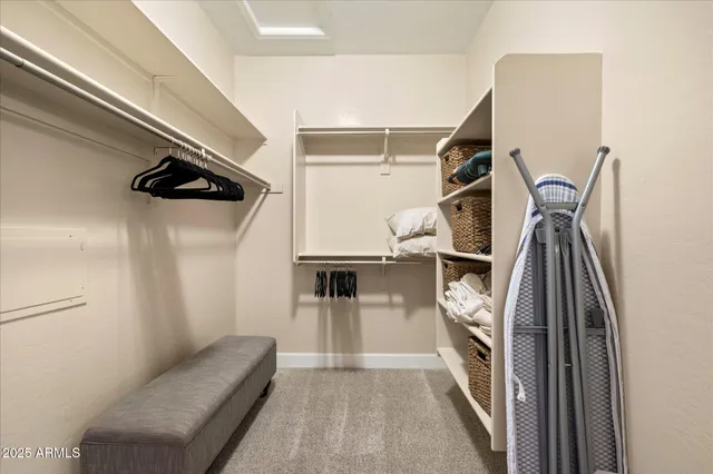 a view of a swimming pool with lawn chairs under an umbrella