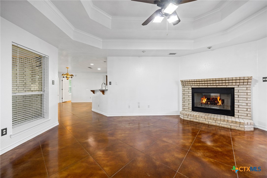 601 7 Ranch Road Salado, TX 76571 - Photo 15 of 44 a view of an empty room with a fireplace and a window