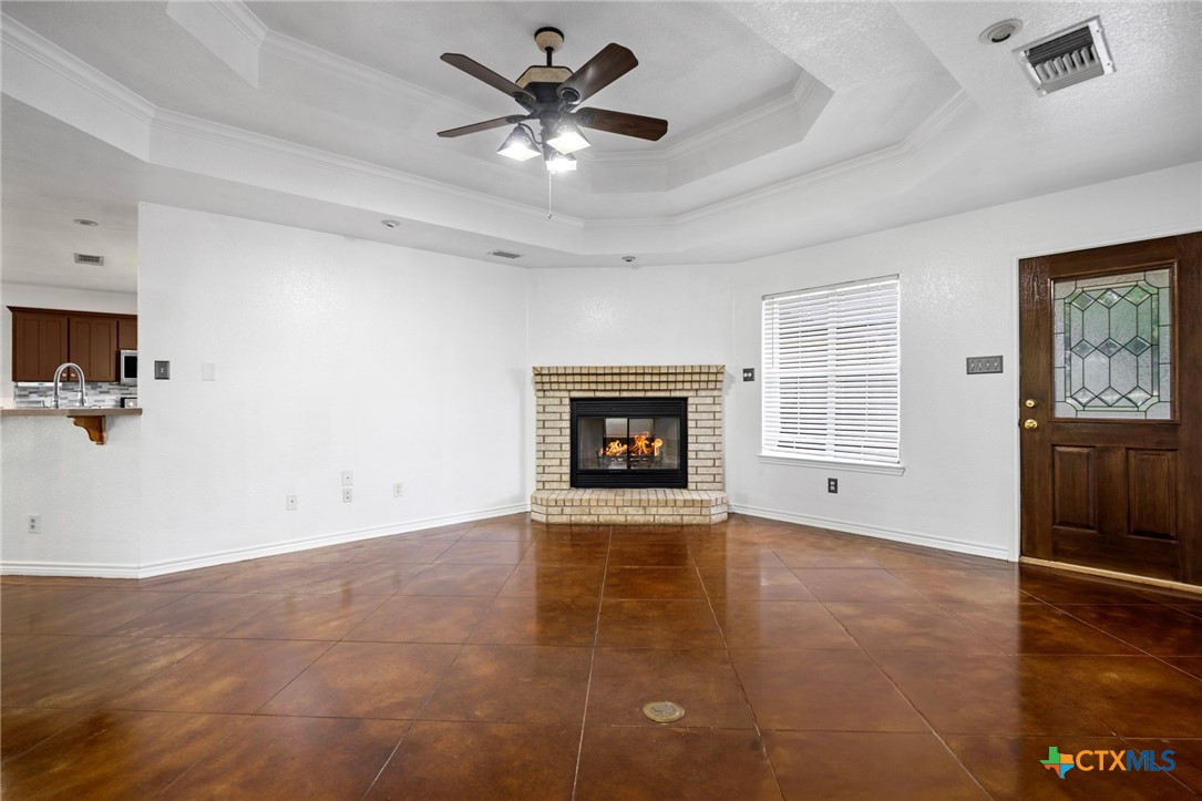 601 7 Ranch Road Salado, TX 76571 - Photo 18 of 44 wooden floor in an empty room with a fireplace