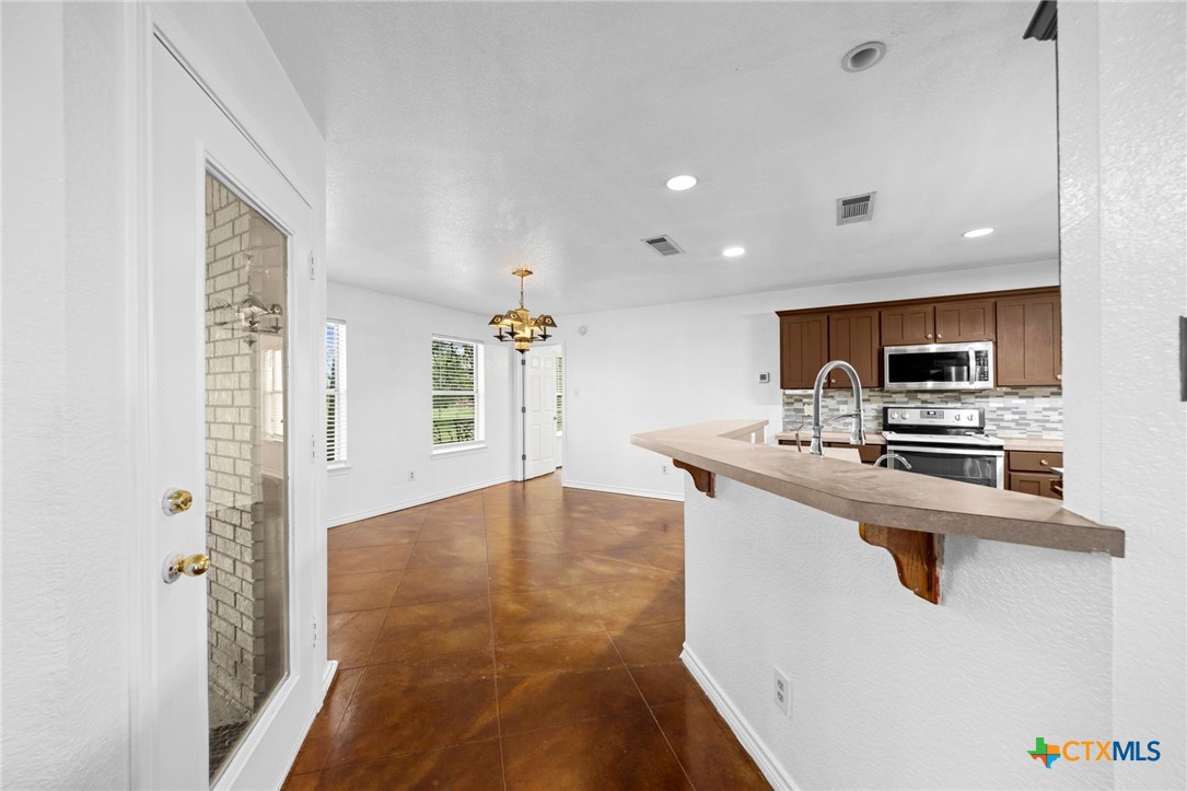 601 7 Ranch Road Salado, TX 76571 - Photo 20 of 44 a kitchen with stainless steel appliances a refrigerator and a stove top oven