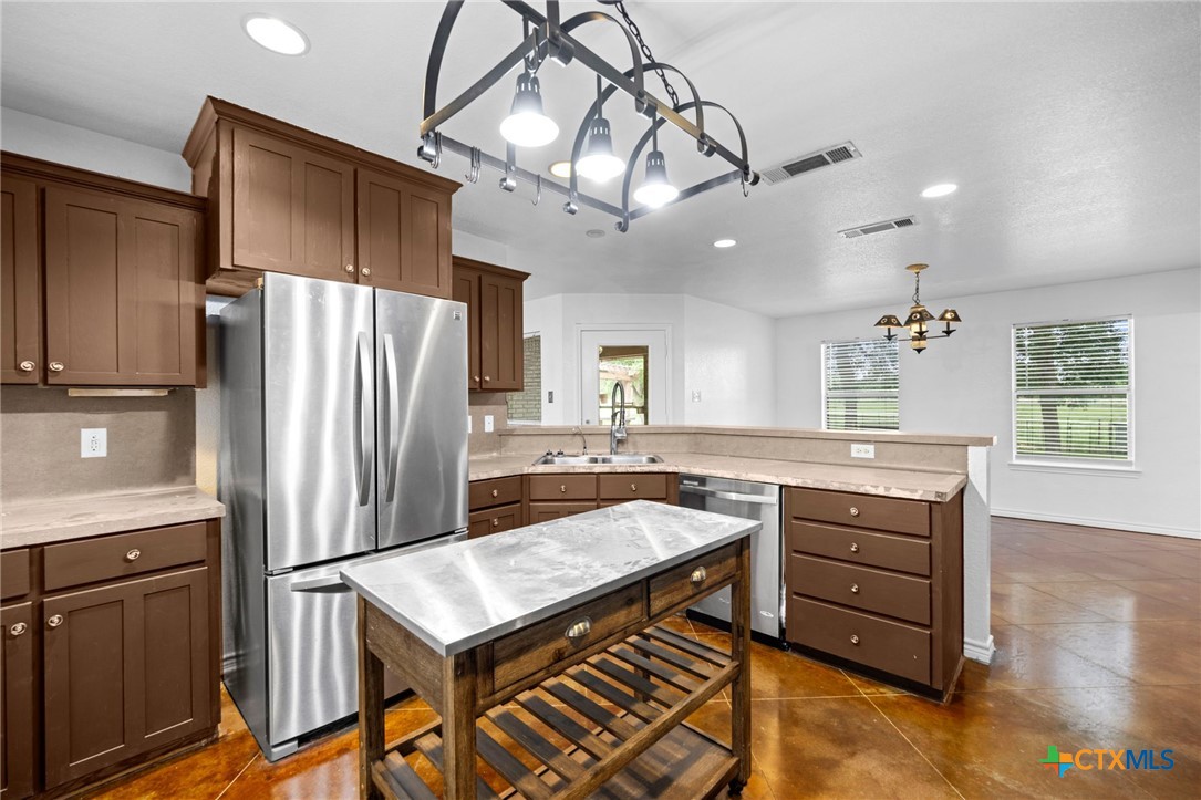 601 7 Ranch Road Salado, TX 76571 - Photo 23 of 44 a kitchen with cabinets and stainless steel appliances