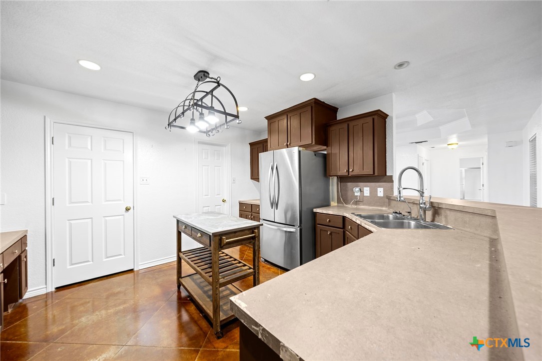 601 7 Ranch Road Salado, TX 76571 - Photo 25 of 44 a kitchen with stainless steel appliances kitchen island a refrigerator sink and cabinets