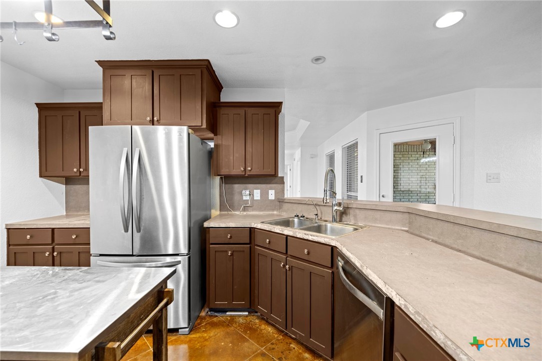 601 7 Ranch Road Salado, TX 76571 - Photo 26 of 44 a kitchen with stainless steel appliances granite countertop a sink stove and refrigerator