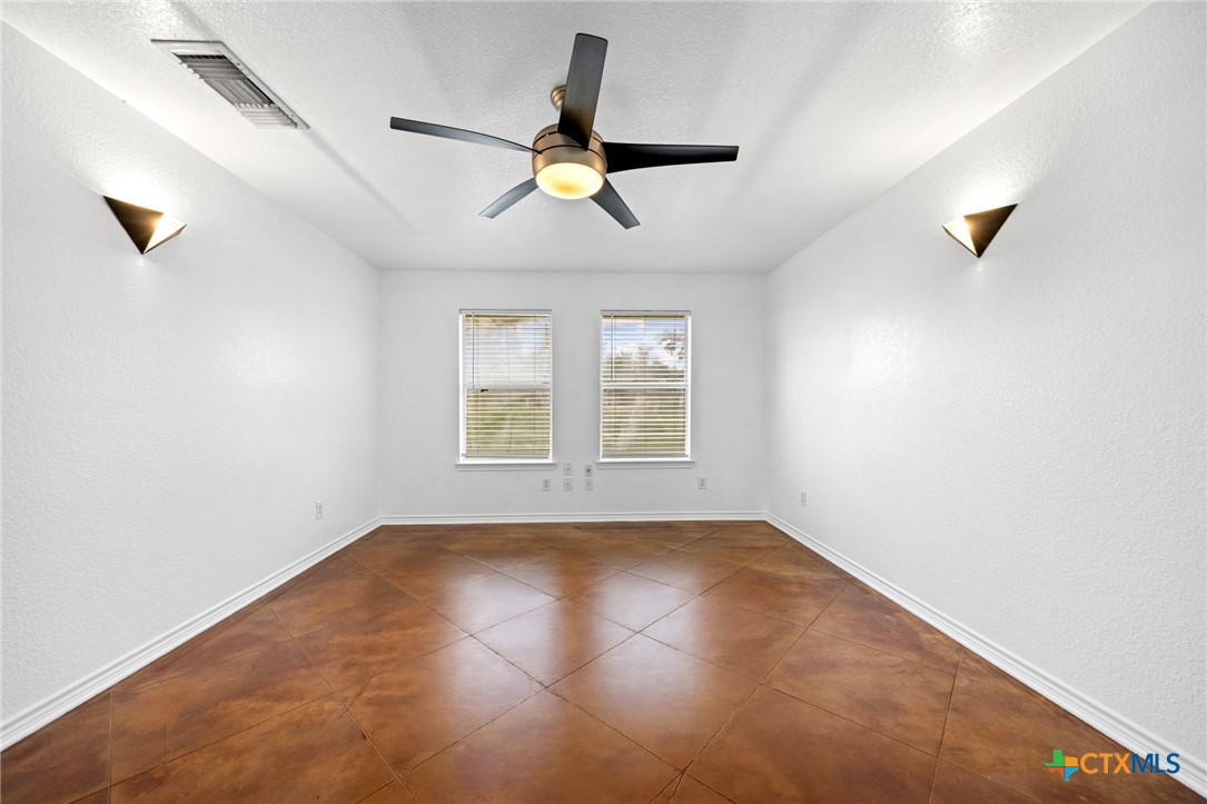 601 7 Ranch Road Salado, TX 76571 - Photo 31 of 44 an empty room with windows and fan