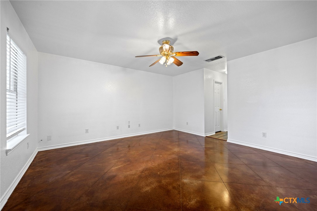 601 7 Ranch Road Salado, TX 76571 - Photo 38 of 44 an empty room with a window and a chandelier fan