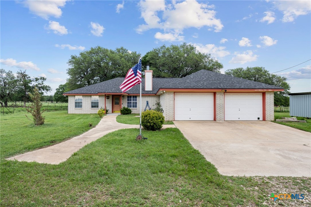 601 7 Ranch Road Salado, TX 76571 - Photo 10 of 44 a front view of a house with a yard and garage