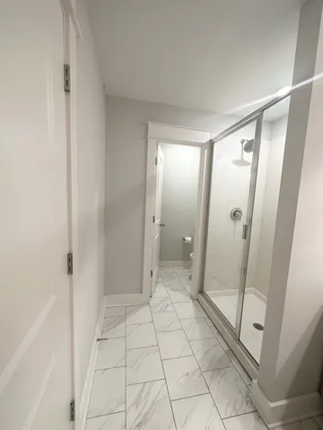 a bathroom with a glass door shower