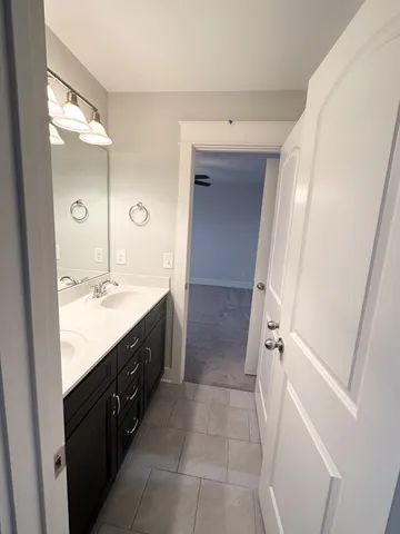 a spacious bathroom with a double vanity sink and mirror