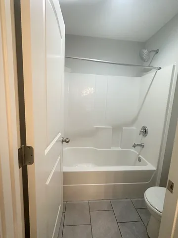 a bathroom with a bathtub and a toilet