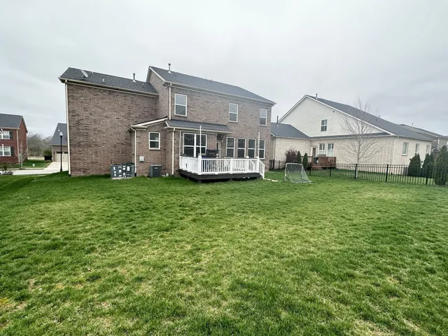 a view of a house with a yard and sitting area