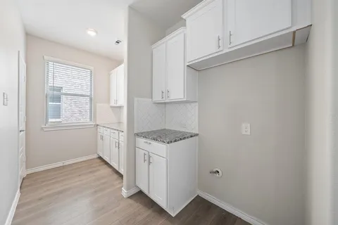 a kitchen with a cabinets and wooden floor