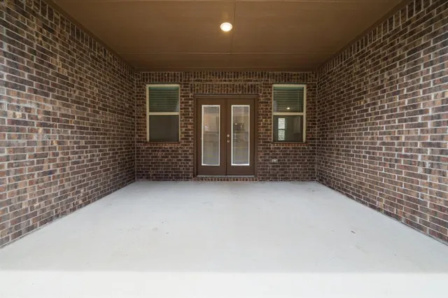 a view of a brick house with many windows