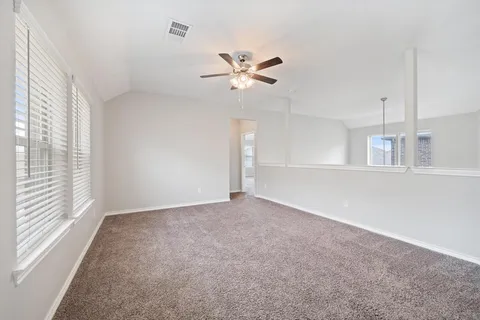 a view of a livingroom with a ceiling fan and window