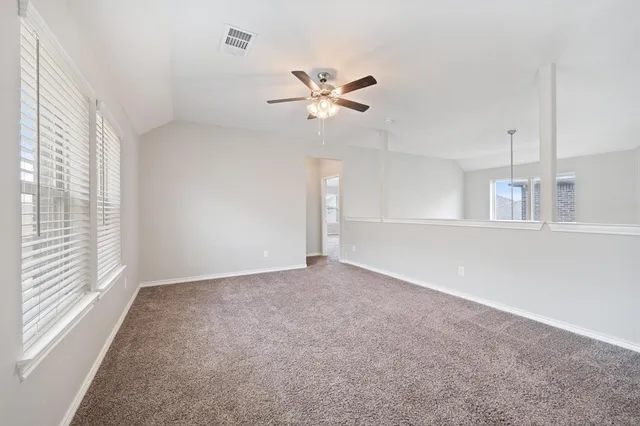 a view of a livingroom with a ceiling fan and window