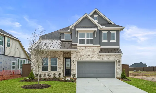 a living room with couches and kitchen view with wooden floor