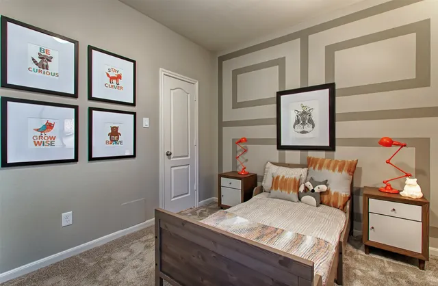 a bed sitting in a bedroom next to a window