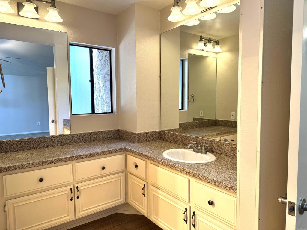 2997 Plaza Leonardo Bonita, CA 91902 - Photo 12 of 18 a bathroom with a granite countertop sink and a mirror