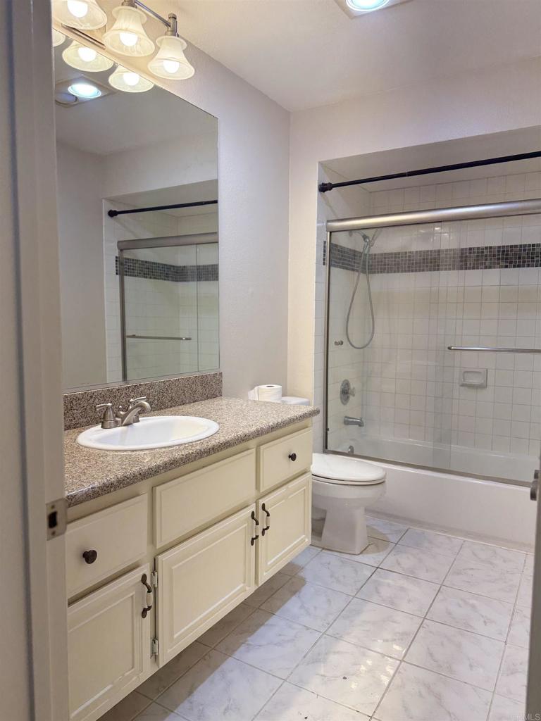2997 Plaza Leonardo Bonita, CA 91902 - Photo 15 of 18 a bathroom with a granite countertop sink toilet and shower