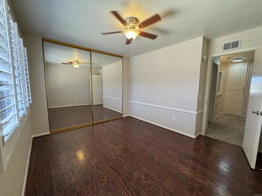 2997 Plaza Leonardo Bonita, CA 91902 - Photo 16 of 18 an empty room with wooden floor and door