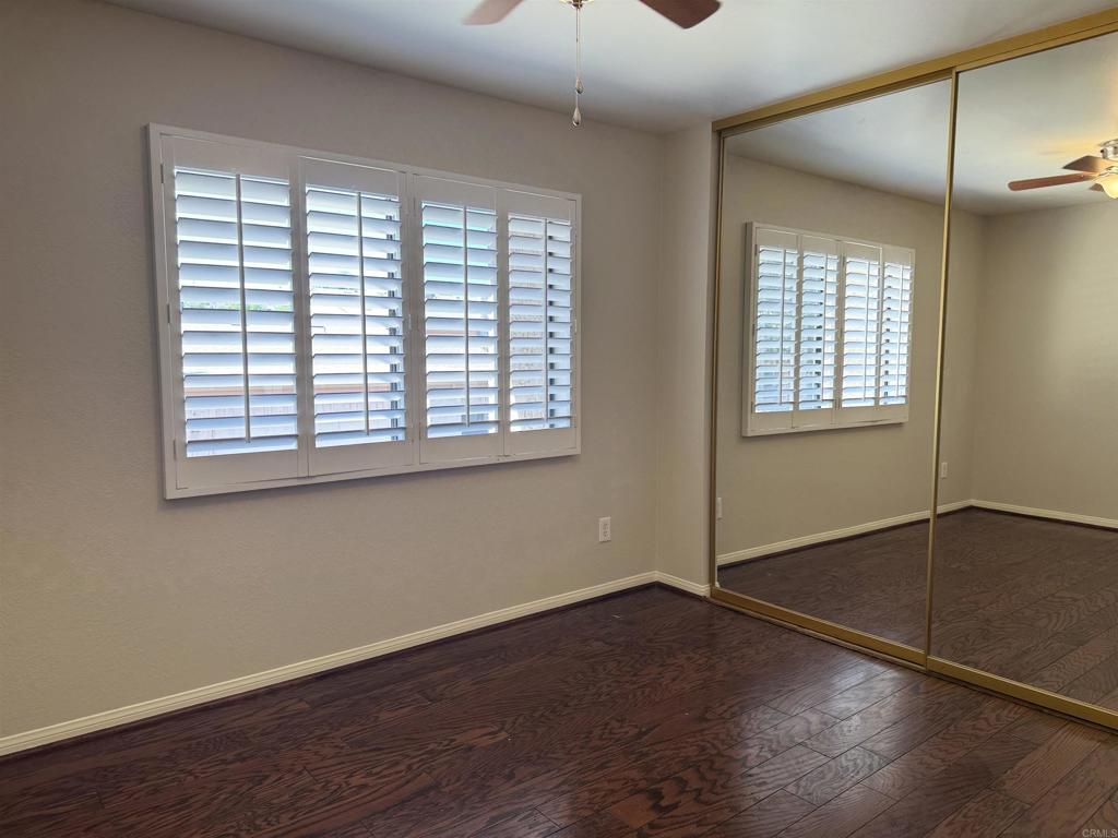 2997 Plaza Leonardo Bonita, CA 91902 - Photo 17 of 18 a view of an empty room with wooden floor and a window