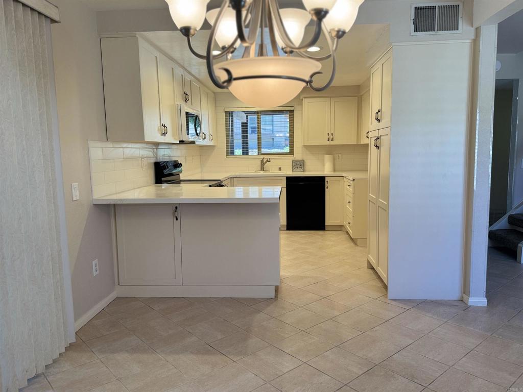 2997 Plaza Leonardo Bonita, CA 91902 - Photo 4 of 18 a kitchen with stainless steel appliances granite countertop a sink a stove and cabinets