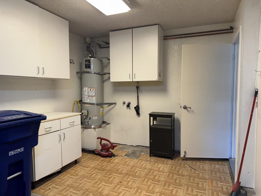 2997 Plaza Leonardo Bonita, CA 91902 - Photo 9 of 18 a kitchen with a refrigerator and cabinets