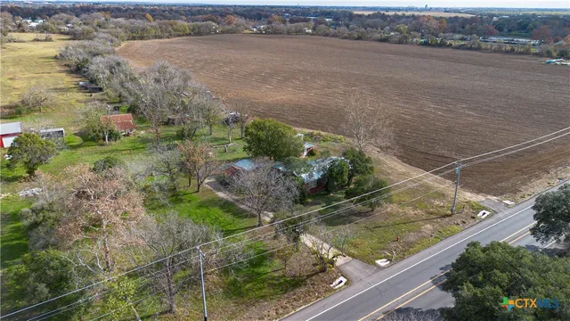 an aerial view of a house with a yard