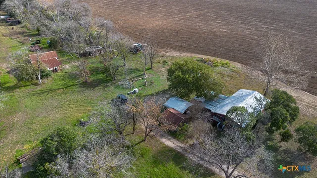 an aerial view of a house with a yard