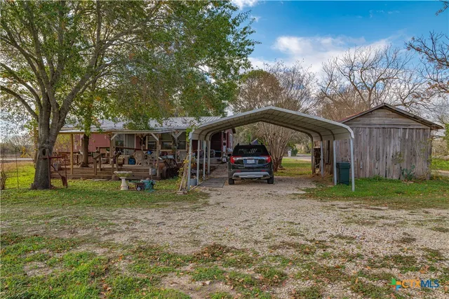 a view of a house with a yard and sitting area