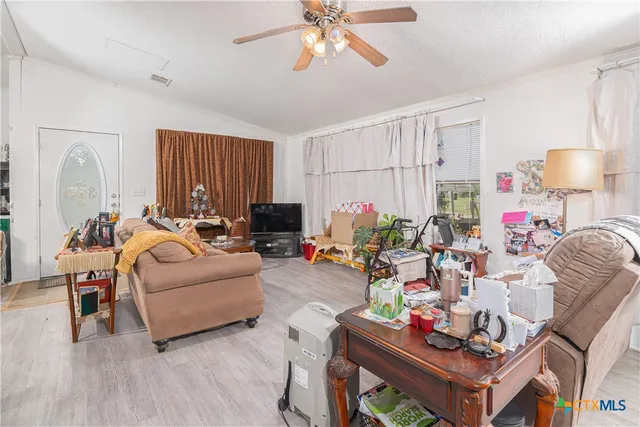 a kitchen filled with white cabinets and white appliances
