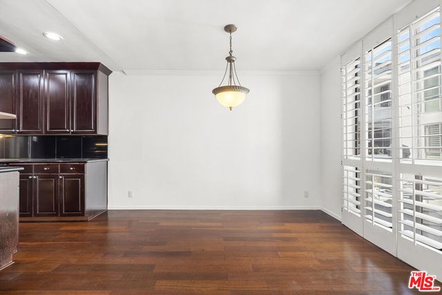 a view of kitchen with granite countertop cabinets and stainless steel appliances