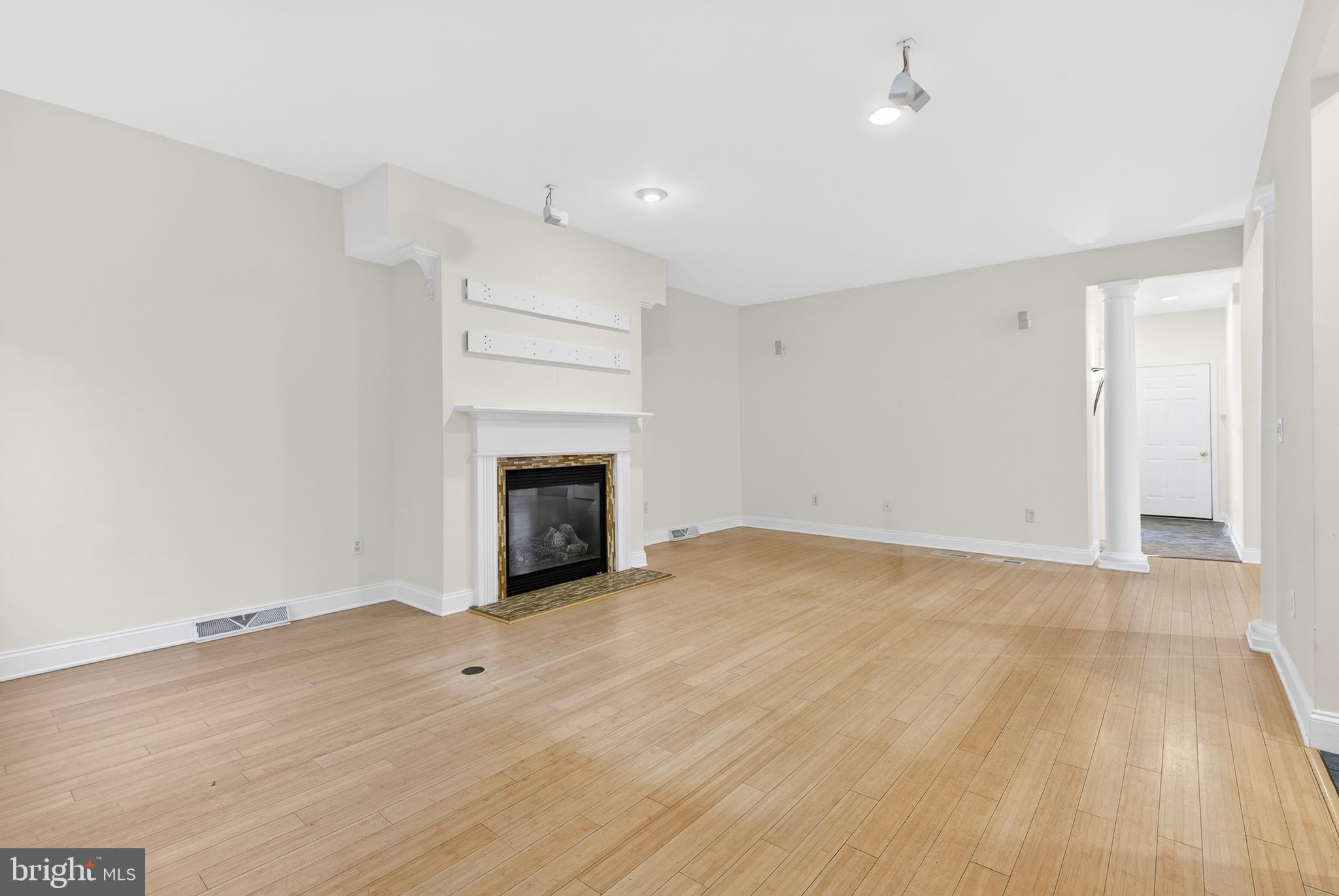 701 Woodfield Drive Lititz, PA 17543 - Photo 13 of 45 a view of empty room with wooden floor and fireplace