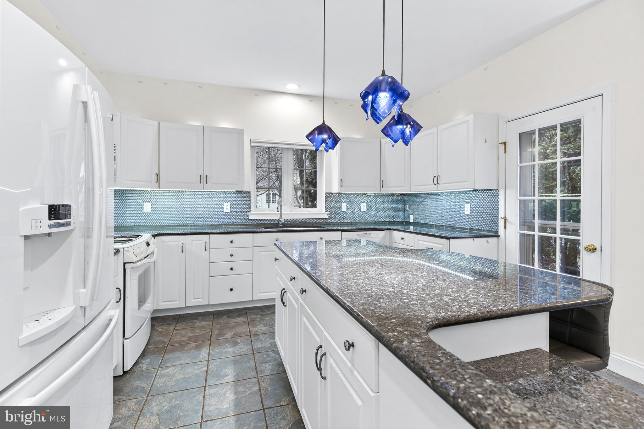 701 Woodfield Drive Lititz, PA 17543 - Photo 17 of 45 a kitchen with kitchen island granite countertop a sink a counter top space and cabinets