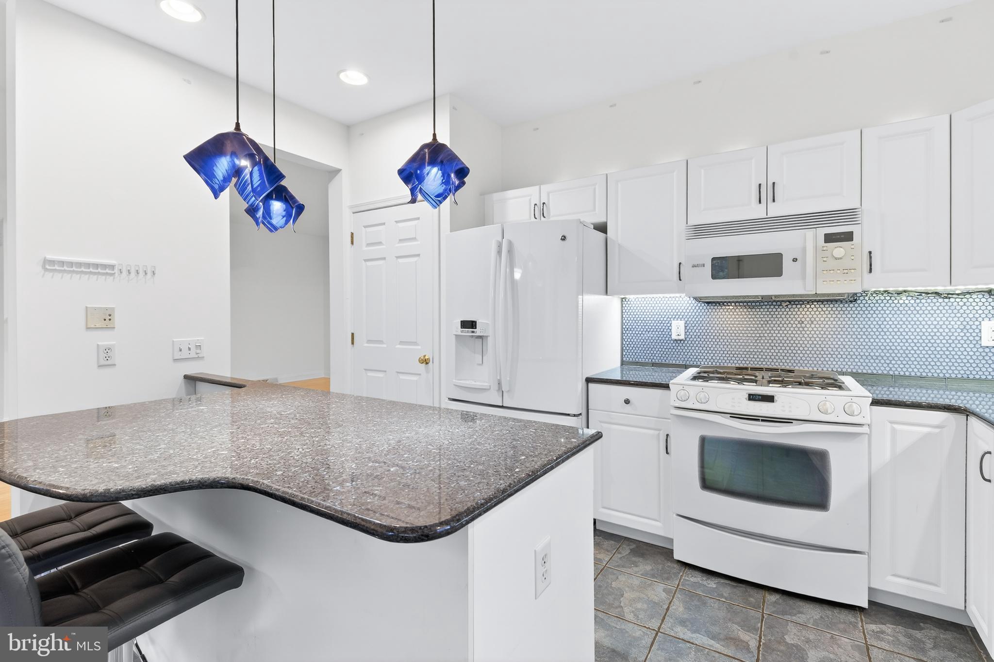 701 Woodfield Drive Lititz, PA 17543 - Photo 18 of 45 a kitchen with stainless steel appliances granite countertop a sink a stove and a refrigerator