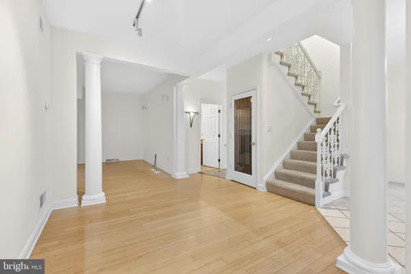 a view of a room with wooden floor and stairs