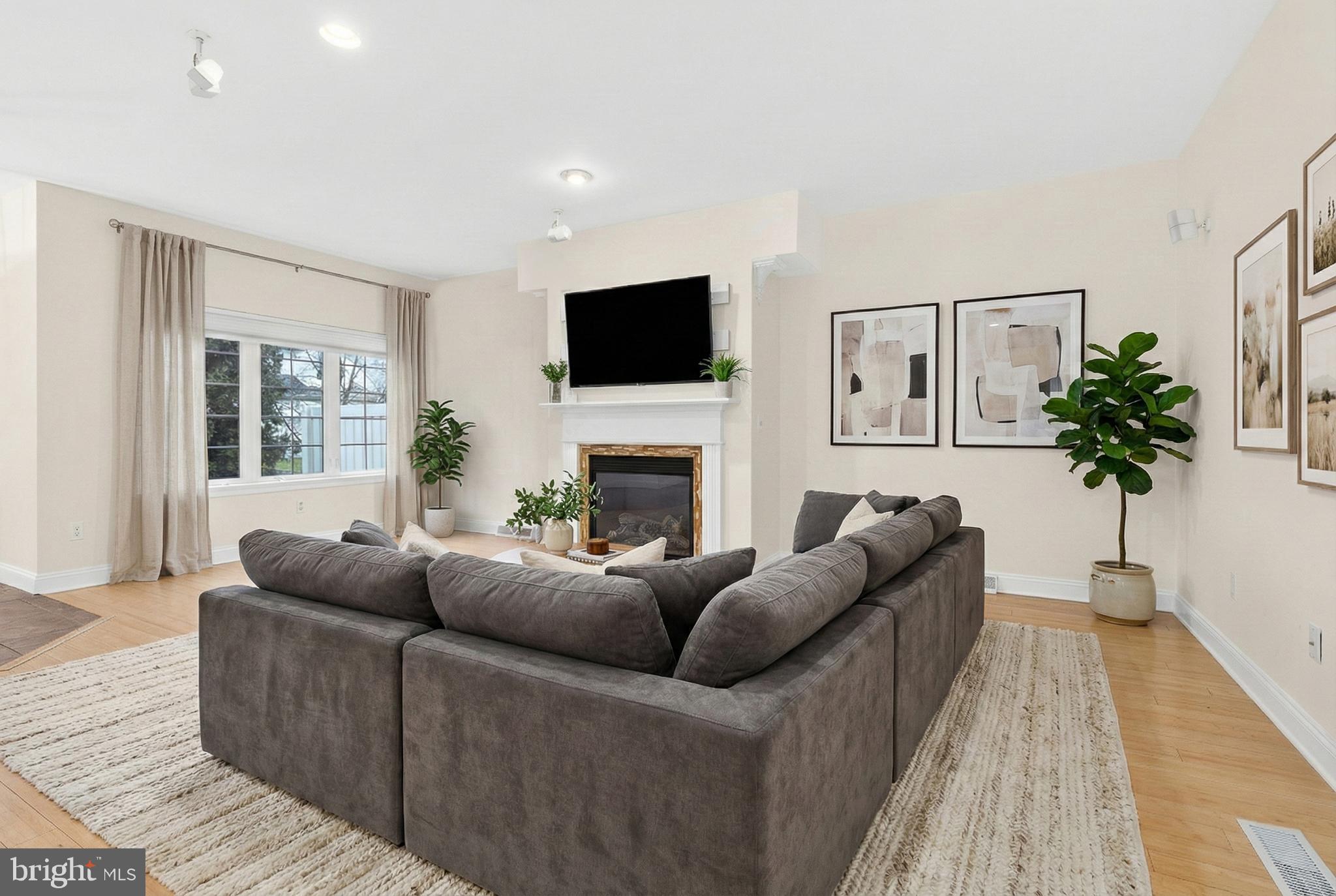 701 Woodfield Drive Lititz, PA 17543 - Photo 10 of 45 a living room with furniture a flat screen tv and a fireplace