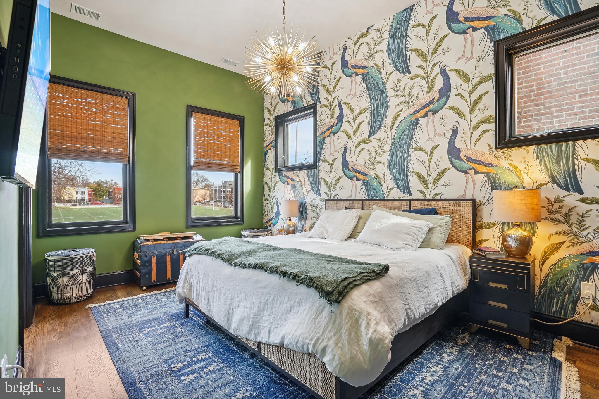 1235 E Street Southeast Washington, DC 20003 - Photo 13 of 43 a bedroom with a bed and wooden floor