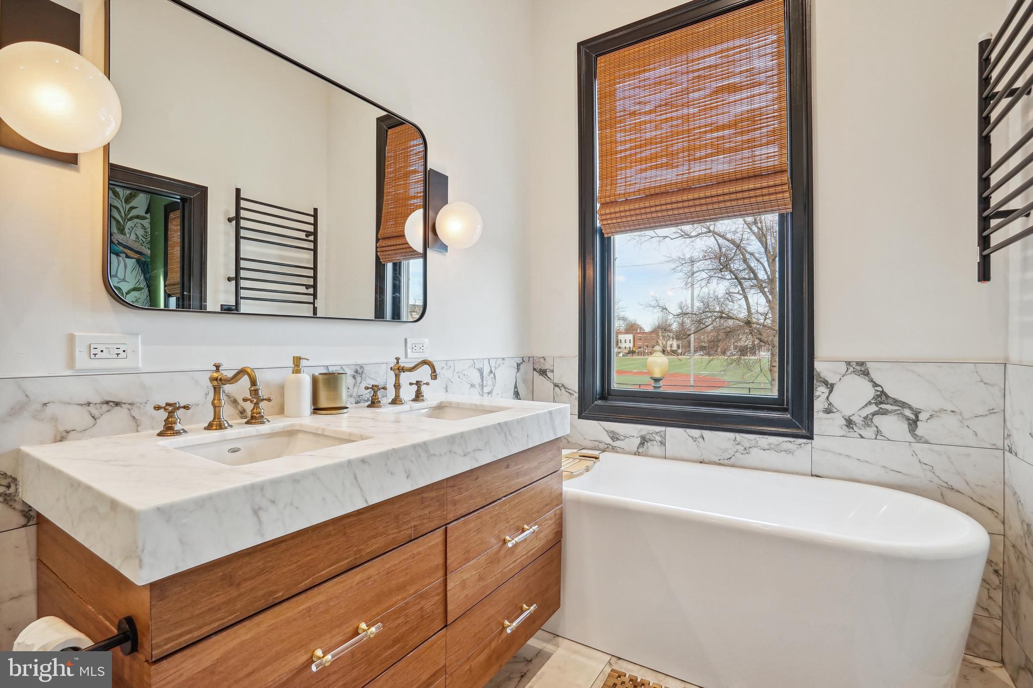1235 E Street Southeast Washington, DC 20003 - Photo 16 of 43 a bathroom with a bathtub a sink and a window