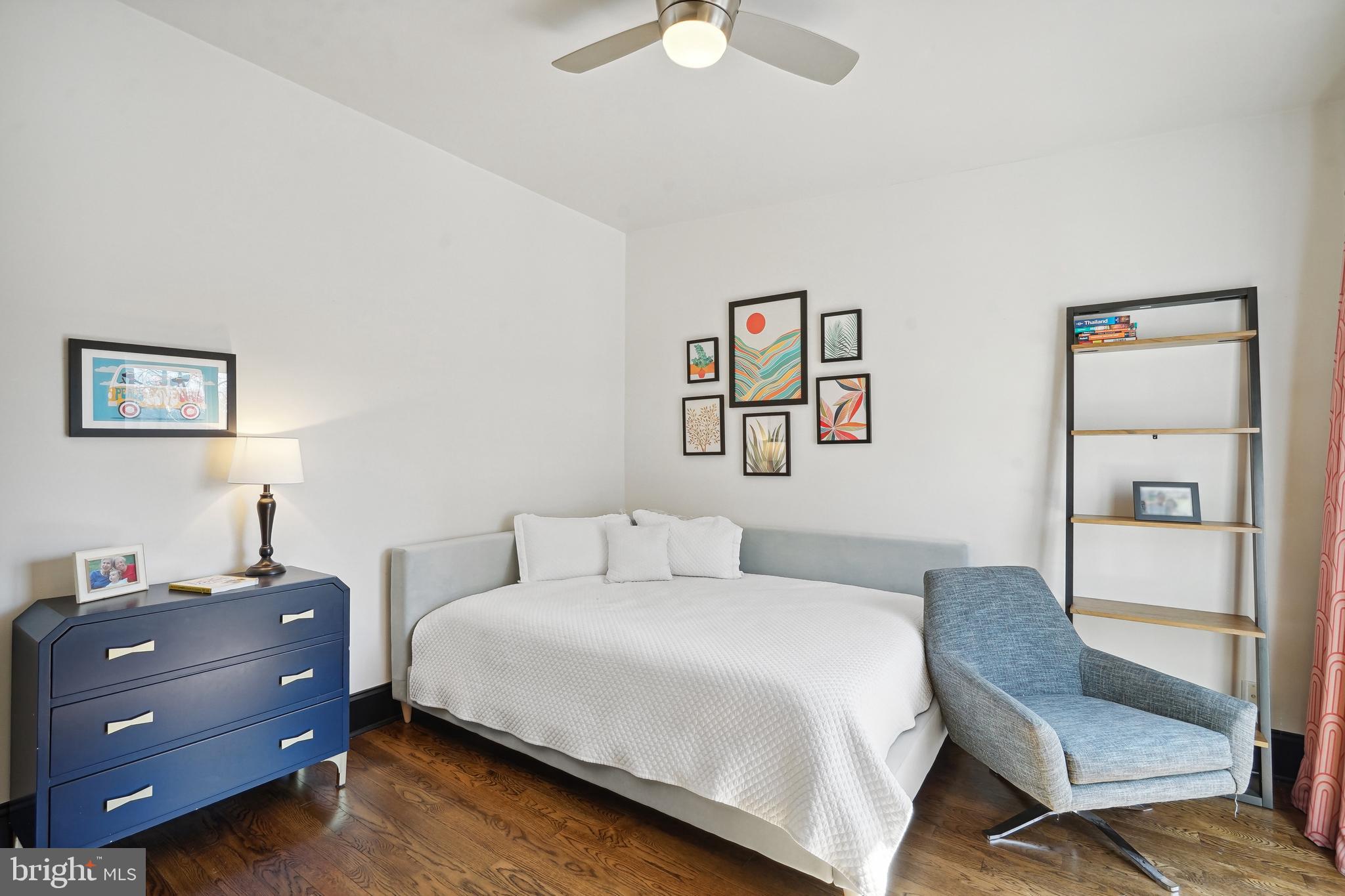 1235 E Street Southeast Washington, DC 20003 - Photo 18 of 43 a bedroom with a bed and a chandelier
