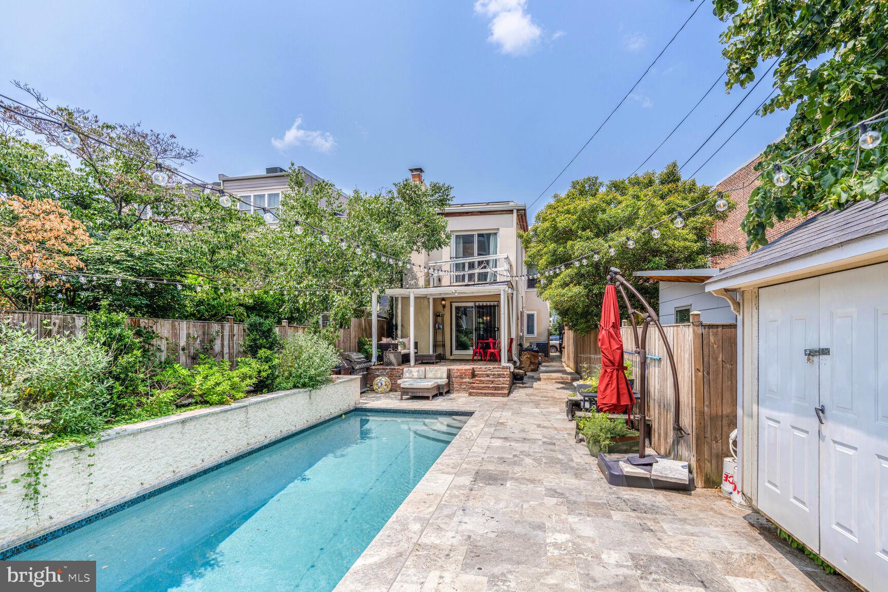 1235 E Street Southeast Washington, DC 20003 - Photo 24 of 43 a view of a backyard with potted plants and a large tree