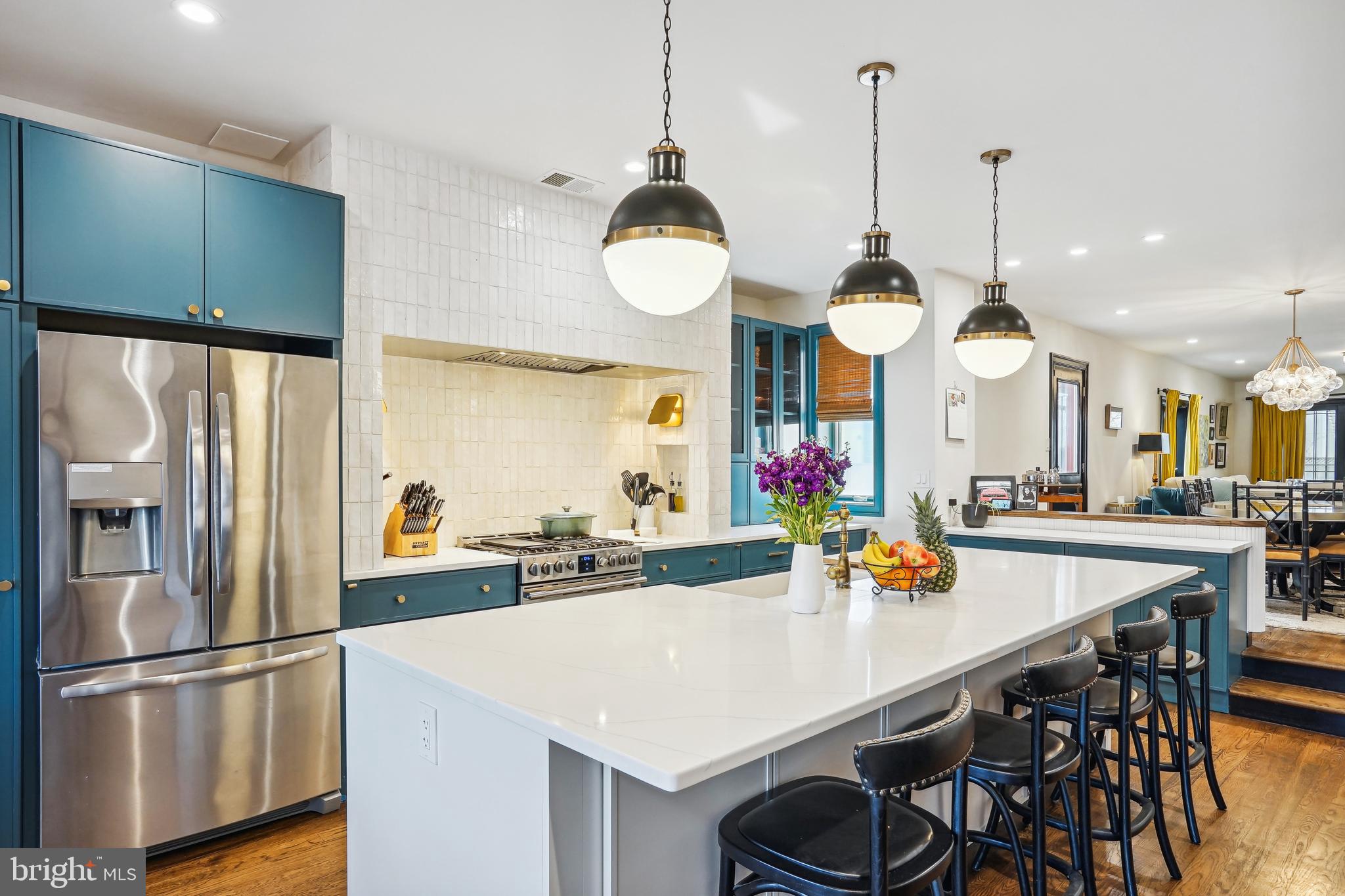 1235 E Street Southeast Washington, DC 20003 - Photo 5 of 43 a kitchen area with stainless steel appliances a dining table chairs and wooden floor