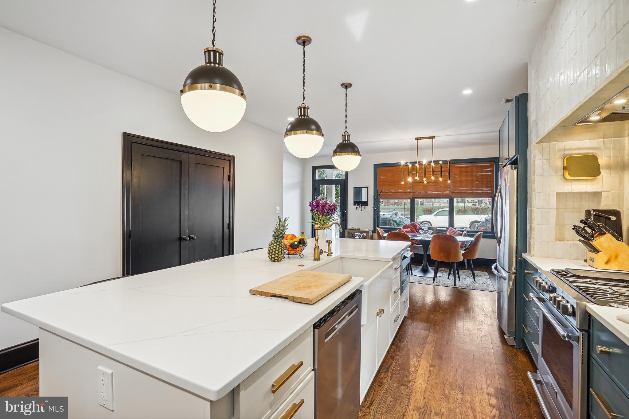 1235 E Street Southeast Washington, DC 20003 - Photo 6 of 43 a large kitchen with a counter space and stainless steel appliances