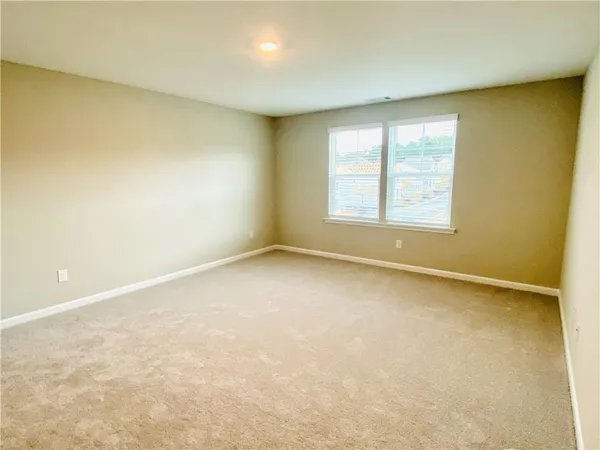 an empty room with a empty space and a window