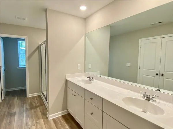 a bathroom with a double vanity sink and mirror